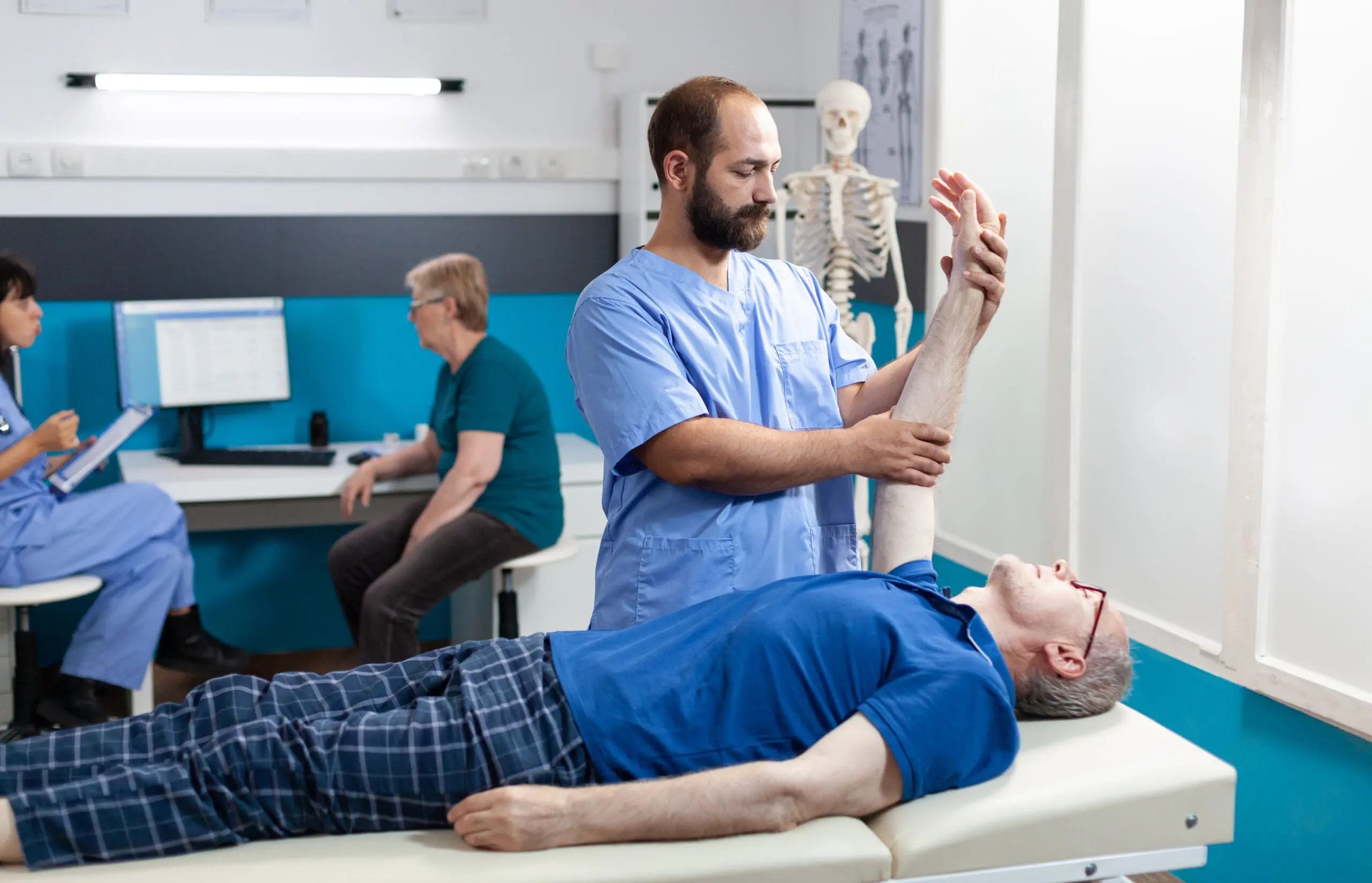 Doctor lifting patient's arm for examination