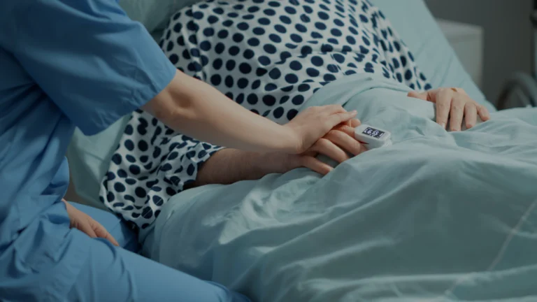 Doctor holding patient's hand