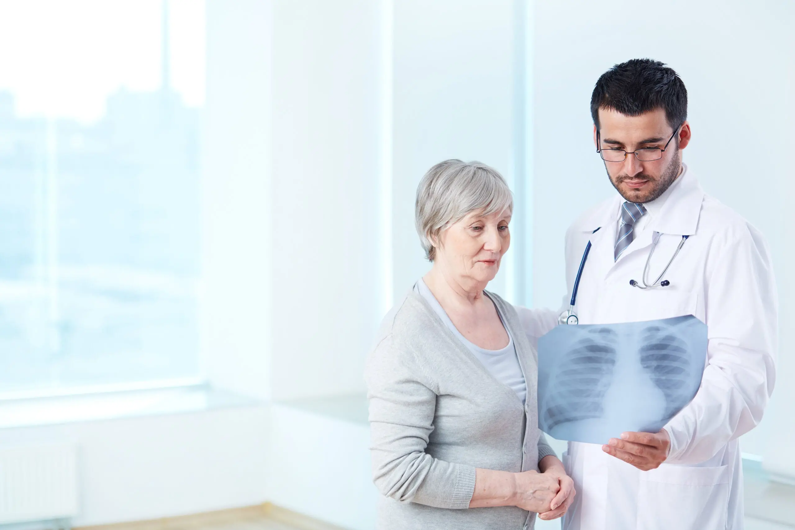Doctor showing lung x-ray to a patient