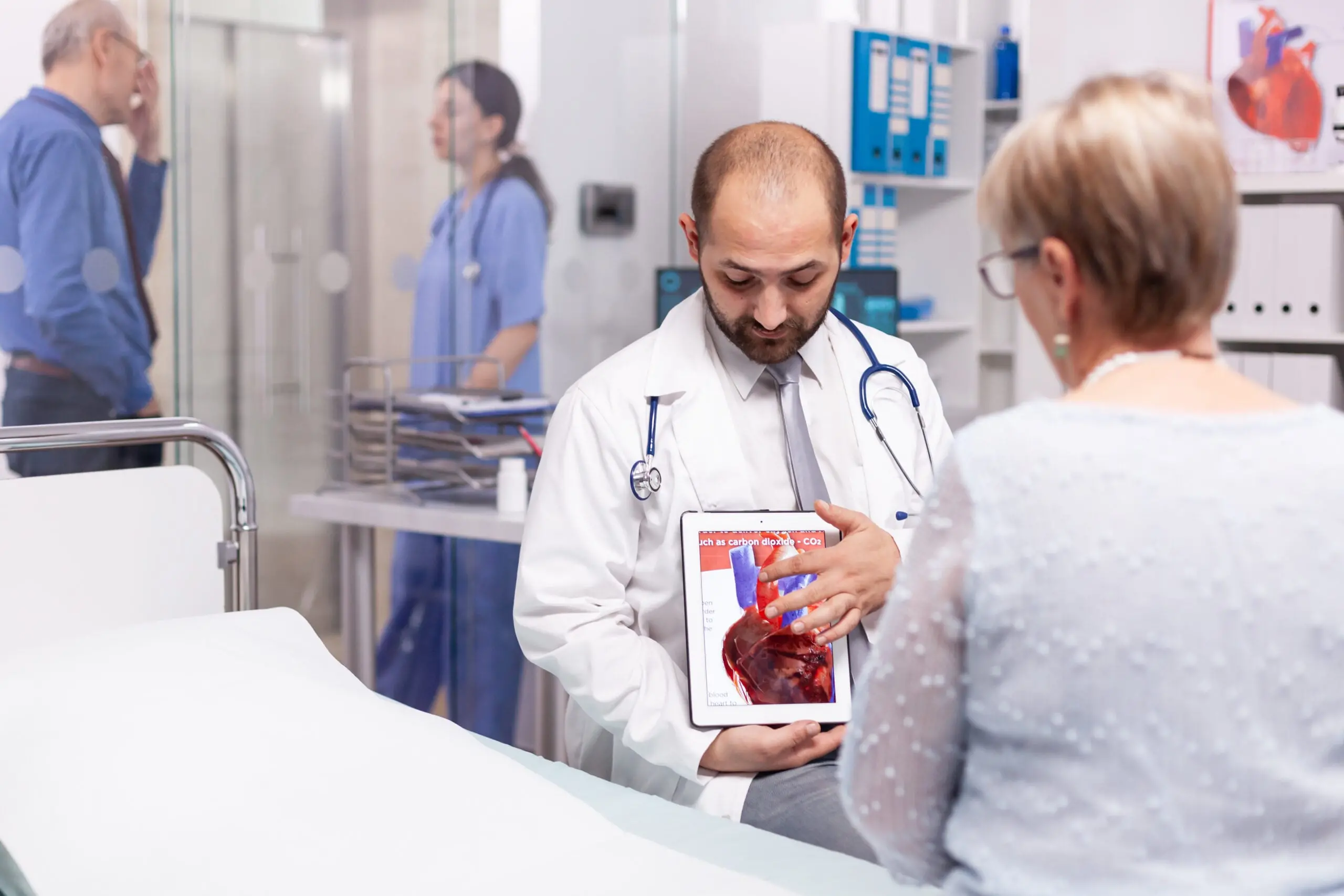 Doctor showing medical information abou the heart to a patient