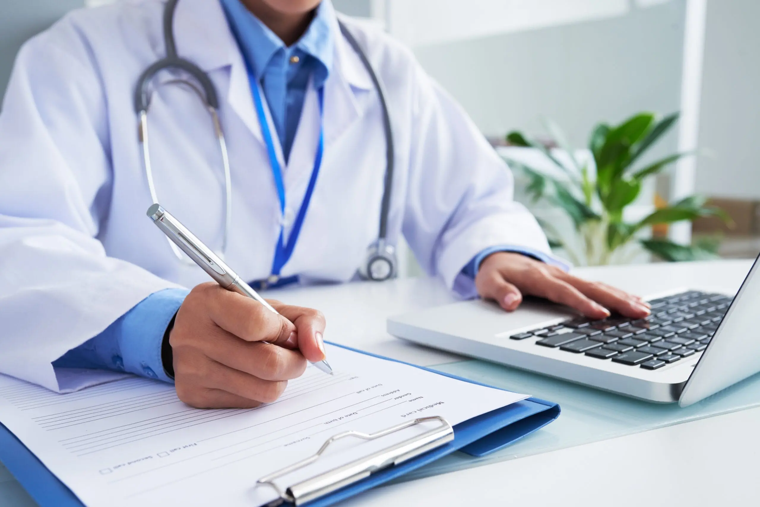 Doctor filling out information on paper
