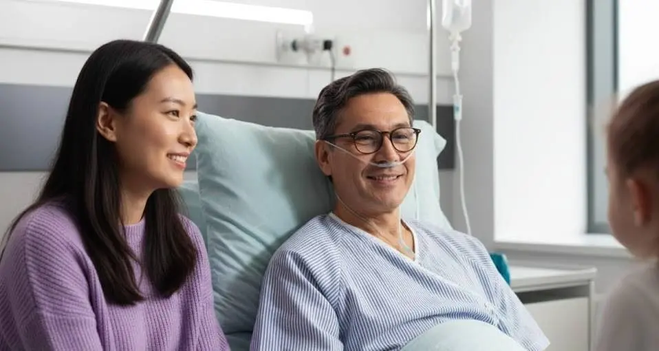 Patient with inserted tube with family members smiling